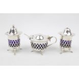 20thC Harlequin Silver Three piece cruet set with associated blue glass liners, Sheffield 1927 &