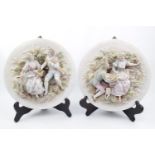 Pair of Circular Bisque pottery figural decorated wall plaques 25cm in Diameter