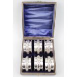 Cased set of 6 Silver Napkin Rings with foliate carved bands, by Henry Williamson Ltd Birmingham