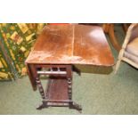 Edwardian Mahogany Sutherland table with turned supports and caster feet