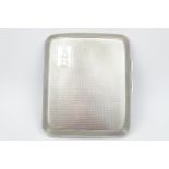 A Silver engine turned cigarette case of curved outline, Chester 1928 by T Nightingale & Son. 85g