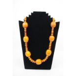Large Butterscotch Amber Necklace of Oval and circular form 130g total weight, 80cm in Length