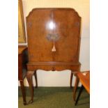 1950s Burr Walnut fitted cocktail cabinet with apron front over long slender cabriole legs. 81cm