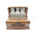 Good quality Edwardian Oak 3 Bottle Tantalus with Silver plated fittings, hinged top above secret