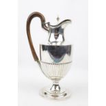 A Victorian half-fluted water jug with an urn finial to hinged cover, 21cm in Height London 1893.