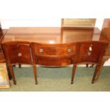 Edwardian Mahogany Serpentine fronted Sideboard with brass drop handles over tapering legs. 153cm in