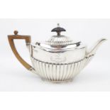 An oval boat-shaped Silver part-fluted teapot on rim foot, Sheffield 1893 by Goldsmiths &