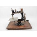 Lead Machine German Childs sewing machine in Walnut domed case