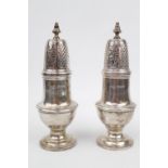 A pair of Silver sugar casters of George III design London 1936 by Goldsmiths and Silversmiths