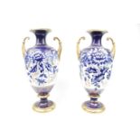 Pair of Leadless Glaze Blue and white transfer printed urn vases with gilded upstretched handles.