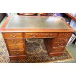 Edwardian Walnut Pedestal desk of 9 drawers with brass drop handles and green inlaid tooled