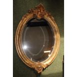 Very Ornate 19thC Oval Gilt Gesso framed mirror with Foliate decoration outside beaded border. 102 x