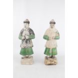 Pair of Chinese green and amber lead-glazed pottery funerary figures in the form of attendants. Each