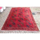 Good quality Red ground Persian Rug with Geometric medallions and tassel ends 325 x 244cm