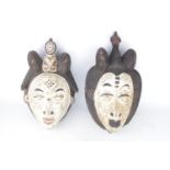 African Punu Type Mask of white face with raised eyebrows with surmounted figural head, 35cm in