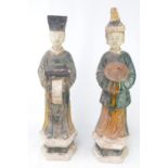 Pair of Antique Chinese green and amber lead-glazed pottery funerary figures in the form of