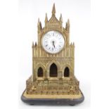 19thC Brass cathedral clock with pillar movement on wooden base with fence applied, with matching