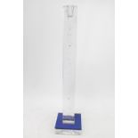 A Kosta Boda clear glass candle stick by Bertil Vallien, textured square column with blue drip