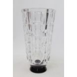 An Orrefors clear glass vase, stepped facet cut sides on black glass foot, designed by Simon Gate,