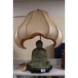 Chinese Bronze Buddha in seated pose mounted lamp on plinth with shaped shade surmounted