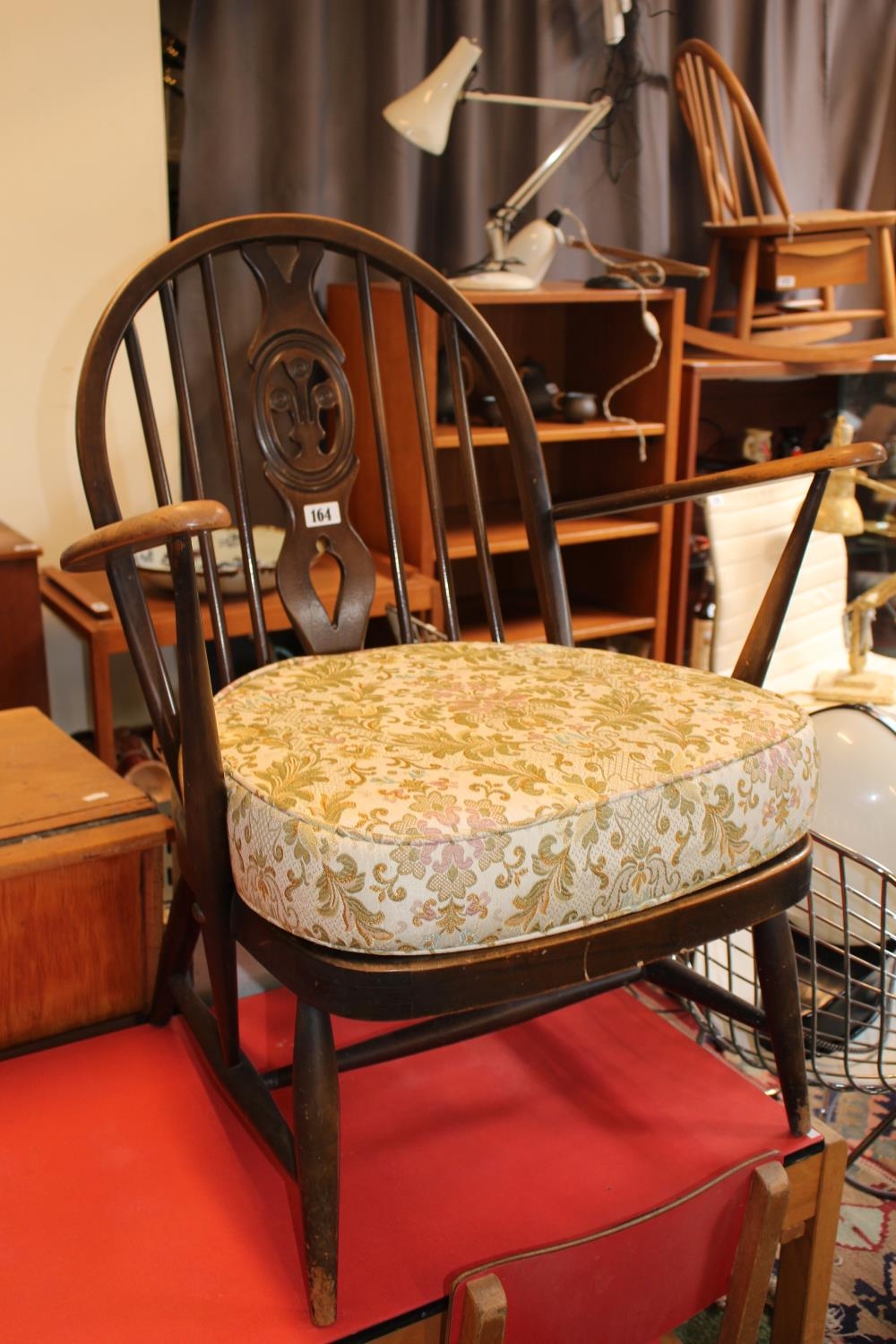 Ercol Mid Tone Elbow chair with upholstered seat, stick back with central carved pierced panel