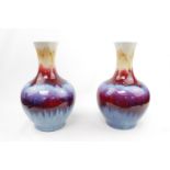 Pair of Chinese Sang-de-boeuf vases with character stamped marks to base. 30cm in Height