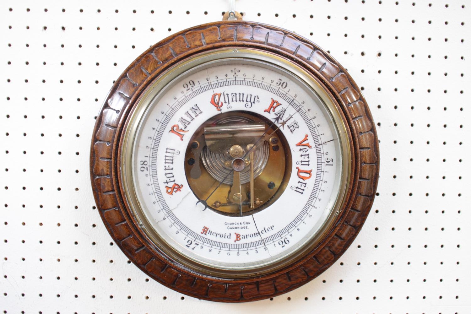 Edwardian Church & Son of Cambridge Aneroid and Barometer in carved circular oak frame. 28cm in