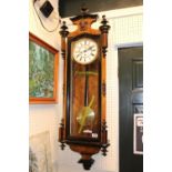 Good Quality Walnut cased wall clock with roman numeral dial and Brass Pendulum and Weight