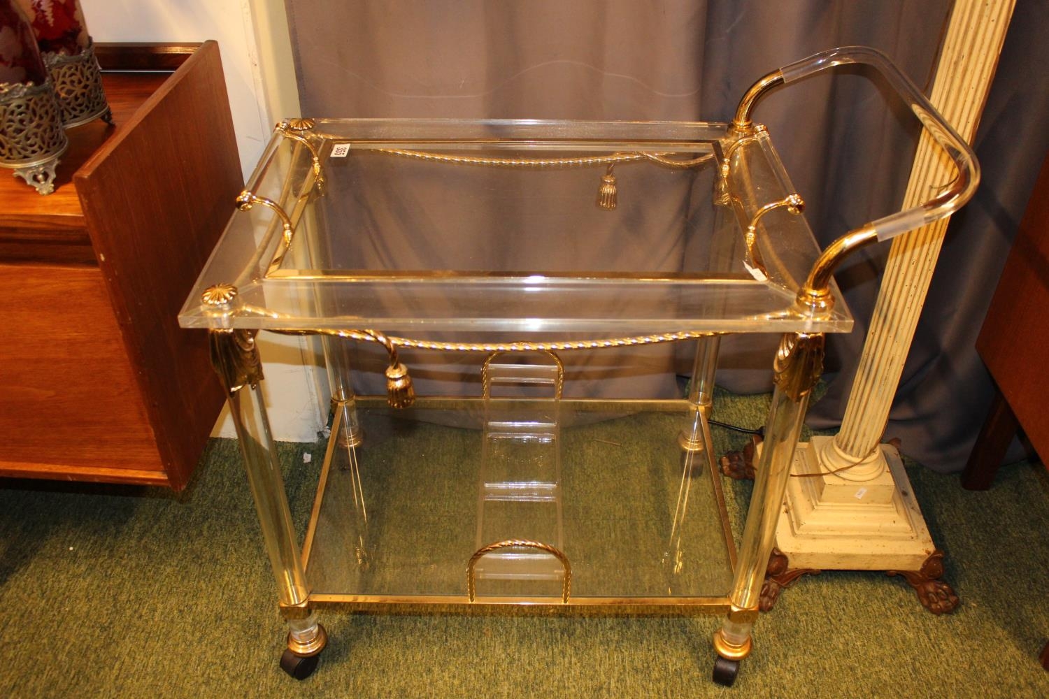 Interesting Perspex and gilt framed cocktail trolley on casters. 80cm in Length