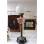 Edwardian Oil Lamp with Pink glass reservoir over Brass column and opaque spherical shade. 71cm in