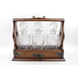 Edwardian Tantalus of 3 Crystal Decanters with Silver plated fittings, complete with key