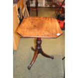 Octagonal Mahogany Wine table on tripod base terminating on brass casters