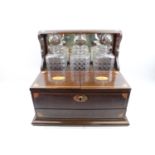 High quality Edwardian Inlaid mahogany tantalus with fitted interior and secret drawer and 3 Cut