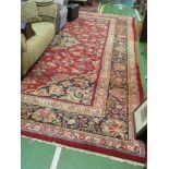 A large Persian carpet wide border and symmetrical design and central medallion, faded on edge in