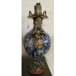 A 19th Century Italian majolica vase with snake and mask handles, blue ground decorated with