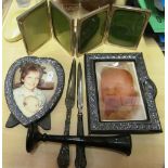 Two silver photo frames, a four-fold frame, two letter openers and vase