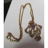 An Edwardian 9ct gold amethyst and seed pearl pendant 3g on gold coloured chain