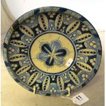 A blue and cream pottery plate