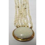 A six string pearl necklace with oval opal clasp