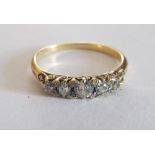 A graduated five stone diamond ring on 18ct gold band size O