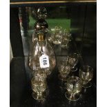 A glass liquer set decanter and six glasses with gilt line decoration