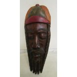 A painted wall mask with carved inscription to reverse From:- Bob Marley to a good chef