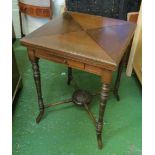 A mahogany envelope card table with cross stretcher