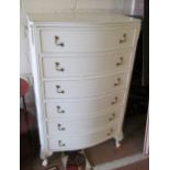 A serpentine white chest of six drawers 30”w x 49.5”h