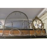 A brass fireguard and oval toilet mirror