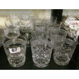 A set of nine cut glass tumblers ( 1 chipped)and a set of seven wine glasses
