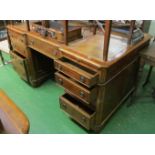 A yew wood partners desk, three frieze drawers, four small and a filing double drawer to one side,