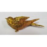 A gold coloured bird brooch with bar marked 18
