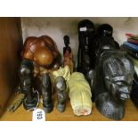 Some carved African heads, treen figures and carved stone figure