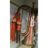 A copper and brass bugle with tassel